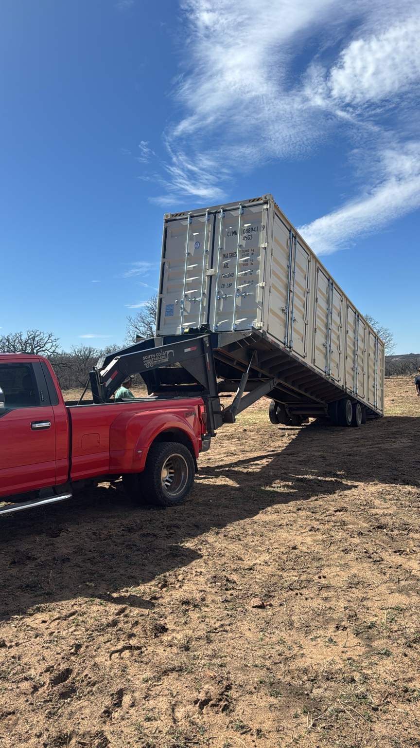 Tilt-bed delivery of a 40-foot high-cube side-open container