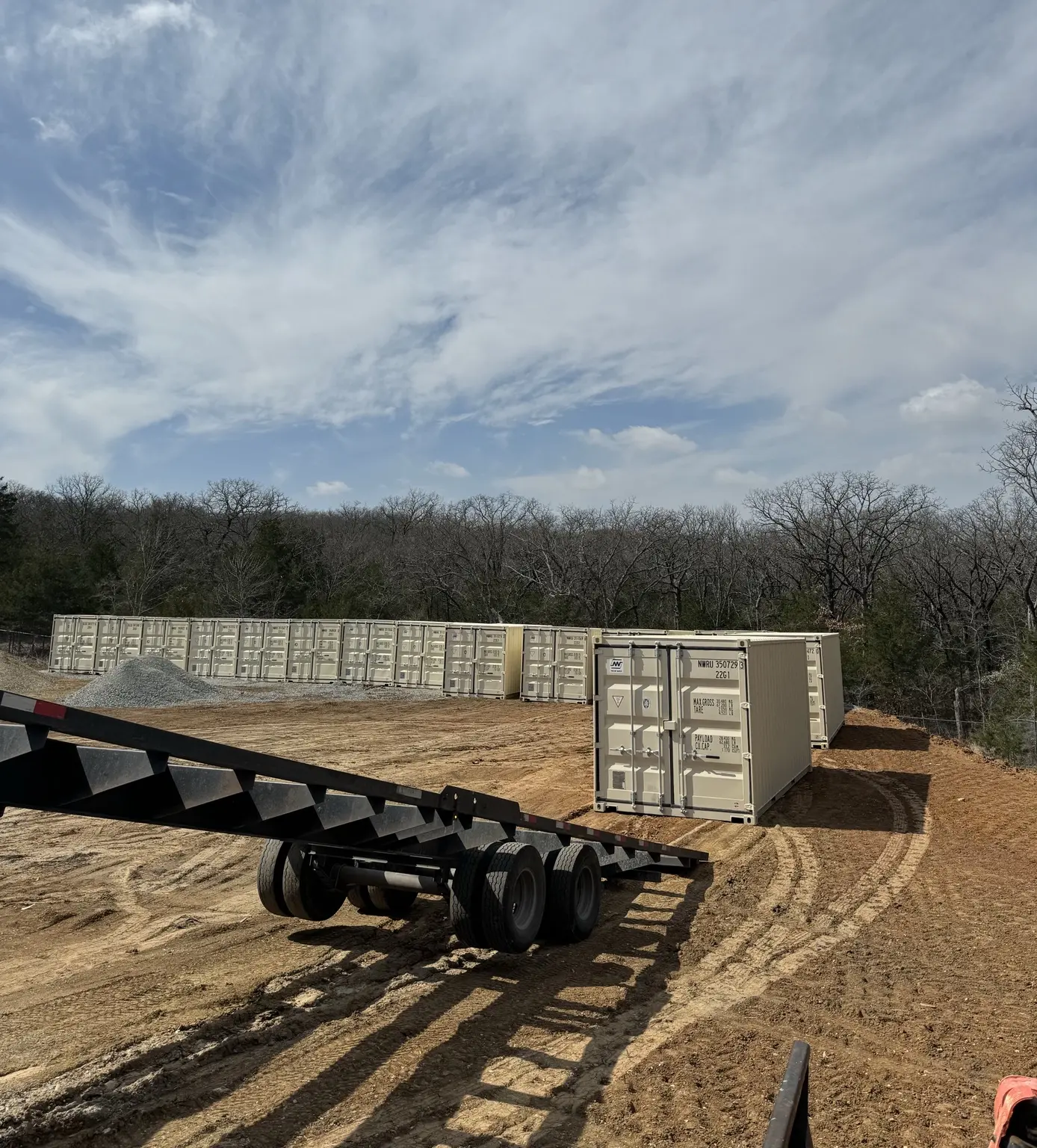 One-trip shipping container inventory and tilt-bed trailer at the Hico yard