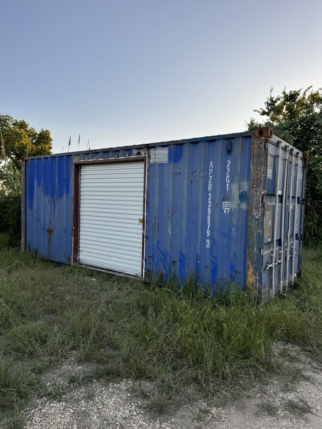 Blue container with a roll-up door installed in its side