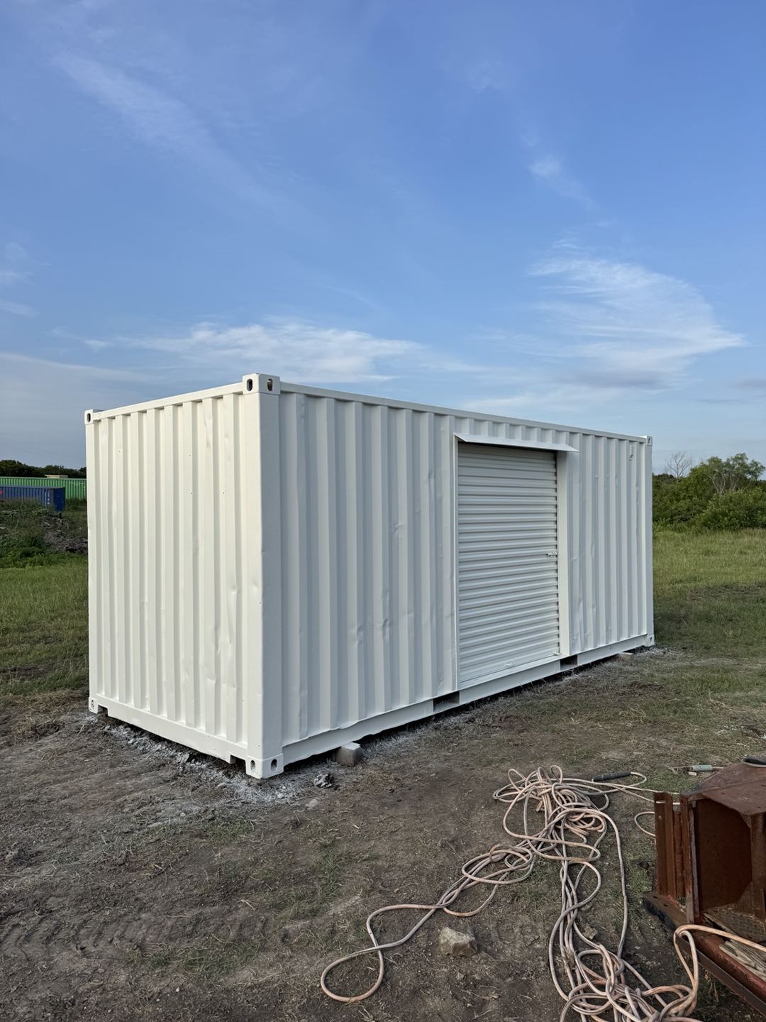 White container with a roll-up door on its side