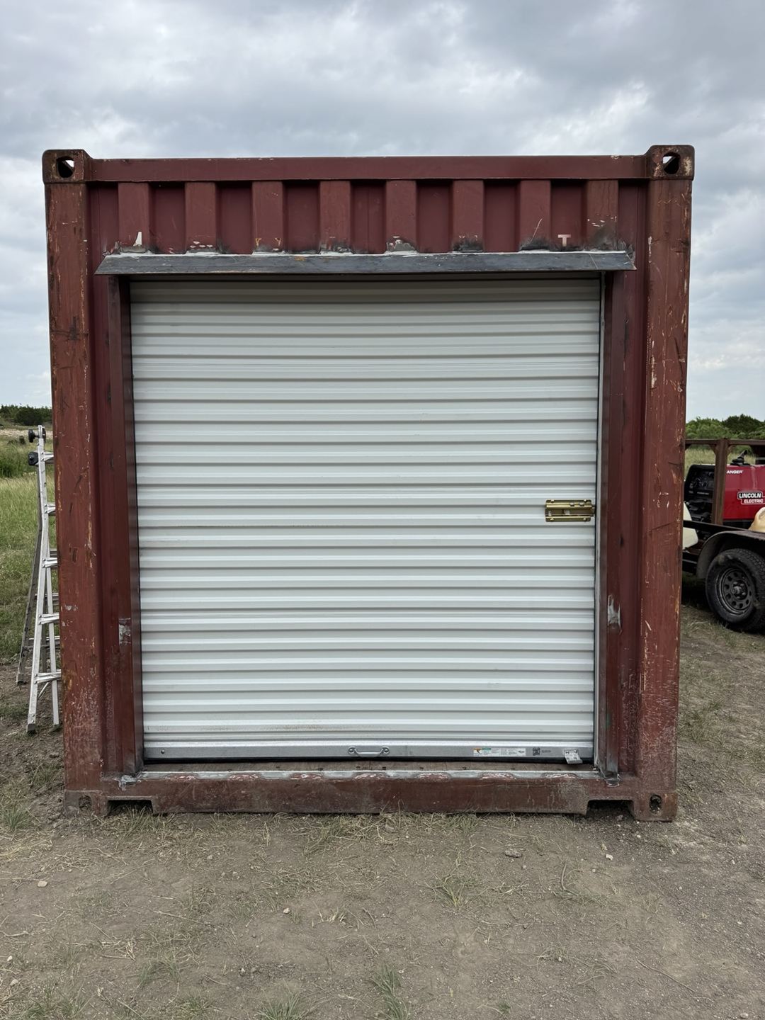 Roll-up door installed at the end of a red container