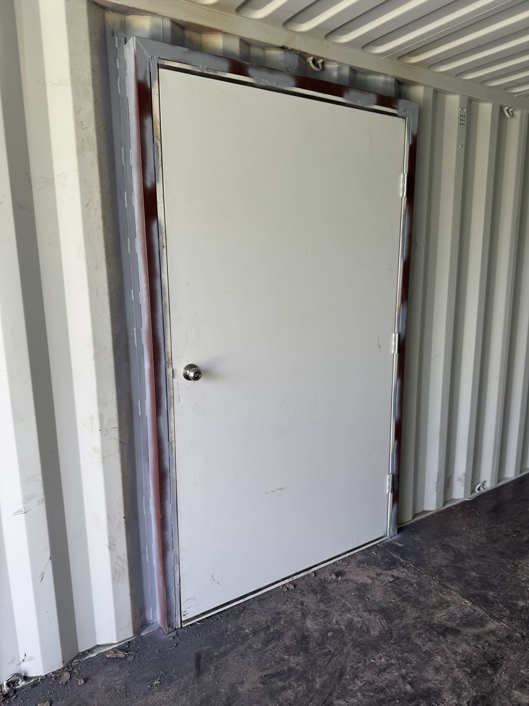 Interior view of a steel personnel door installed in a container