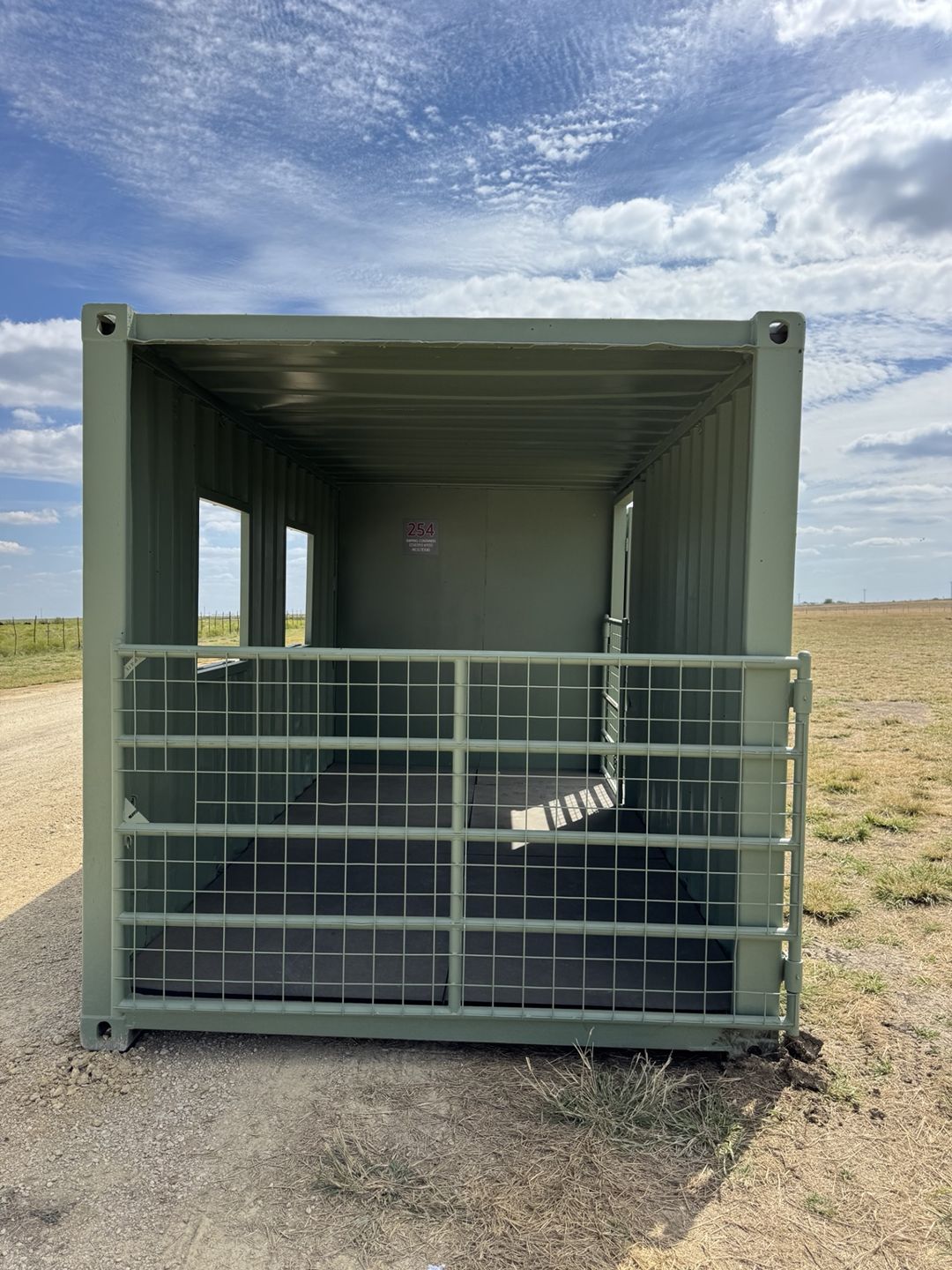 Custom green container with an open end and a welded mesh gate