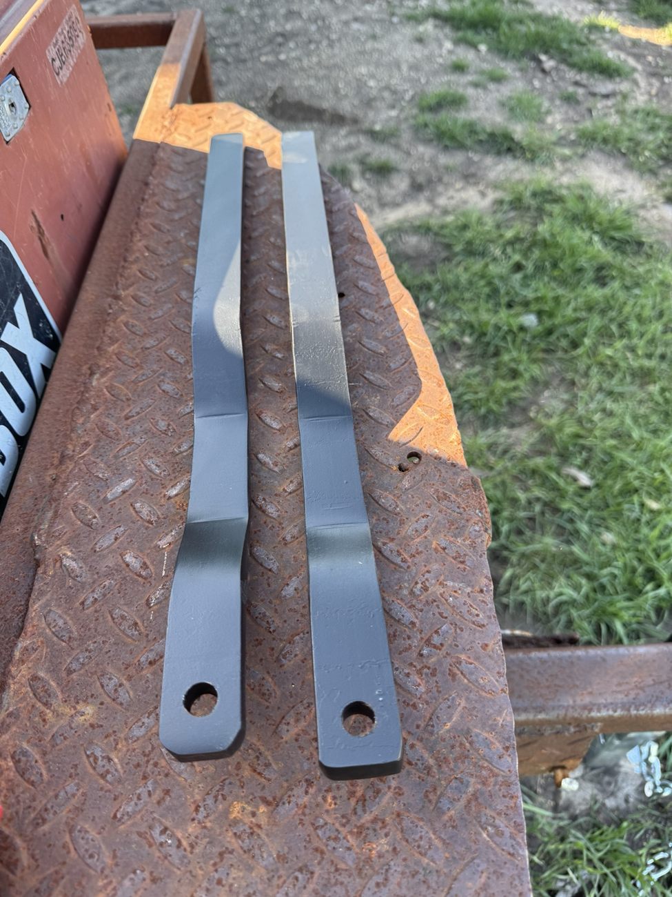 Two manufactured metal retrofit handles before installation
