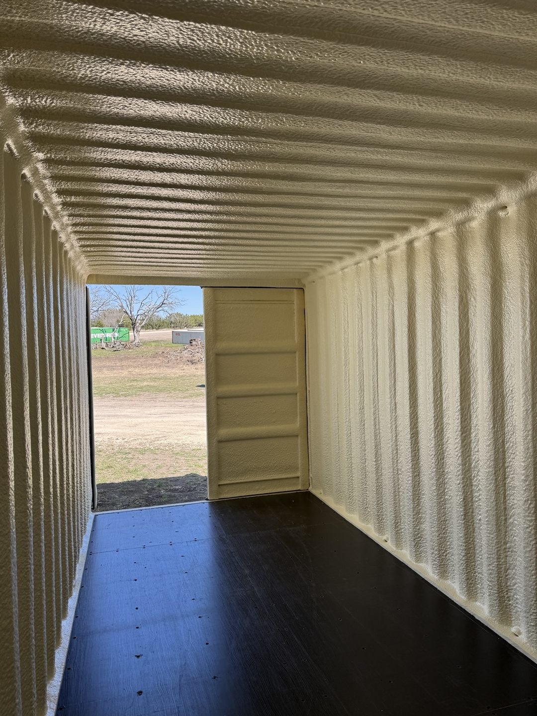 View toward the door from inside a spray foam coated container